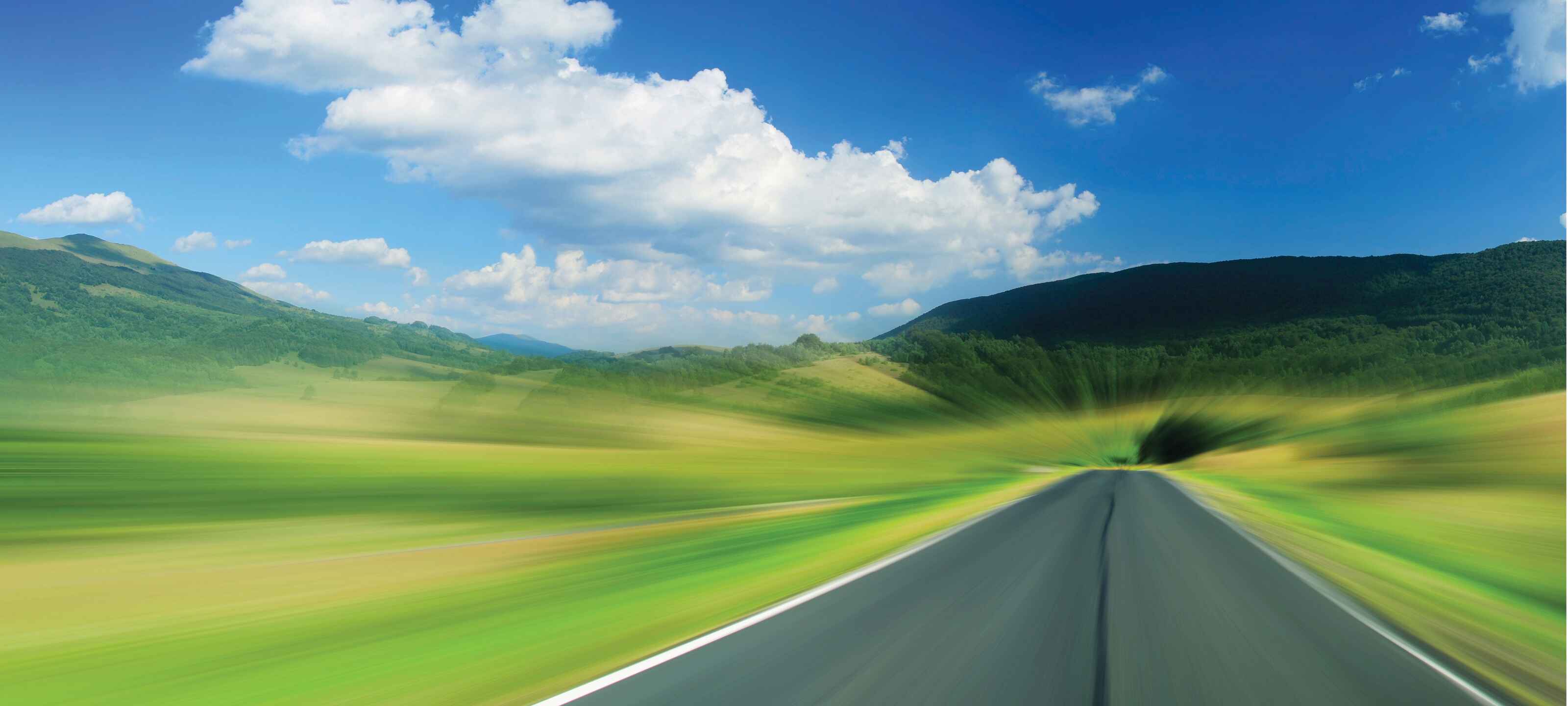 Road with green fields on both sides