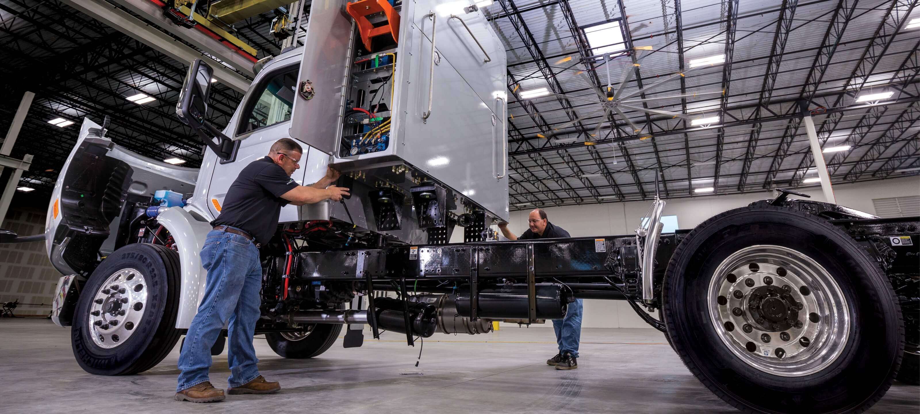 Technicians installling Cummins Clean Fuel Technologies Back of Cab System