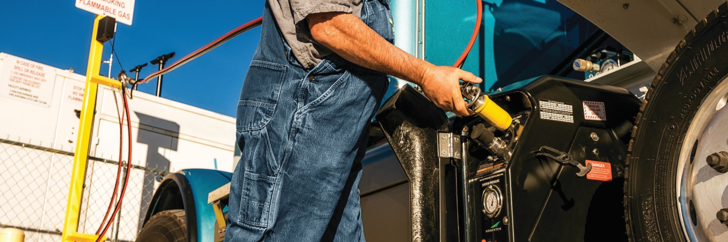 Driver refueling CNG fuel tank on truck